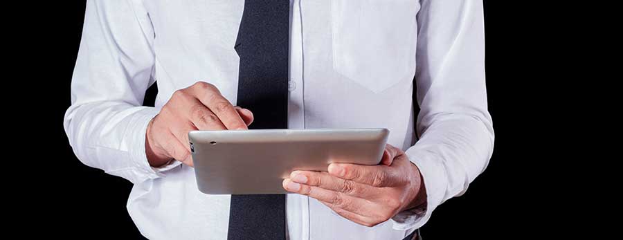 man using tablet with black background